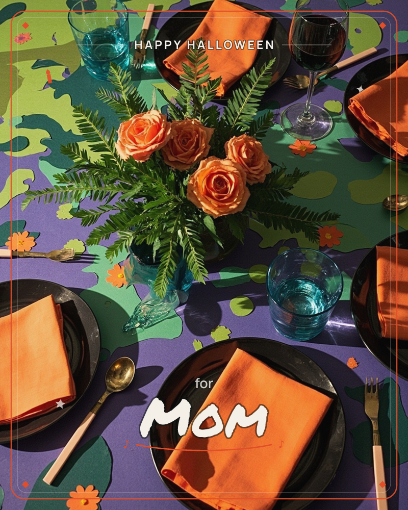 An overhead shot of a festive table set with black plates, folded orange napkins, and teal glassware, arranged on a bold purple and green patterned…, a halloween e-card design