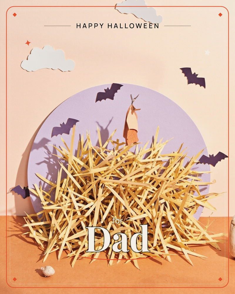 A paper-craft Halloween scene shows a mound of golden straw piled in front of a lavender paper moon, with cut-paper bats scattered across a peach sky, a halloween e-card design