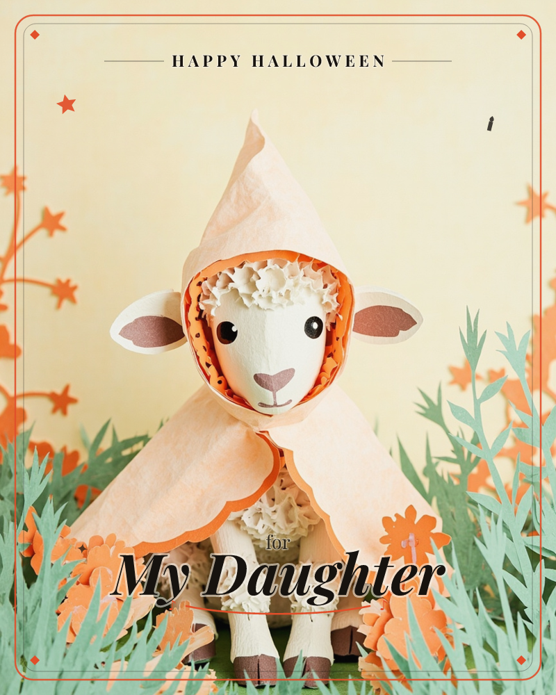 A paper-craft lamb with curly wool and a peach hooded cloak sits amid a handmade meadow of sage-green grasses and orange paper blossoms, a halloween e-card design