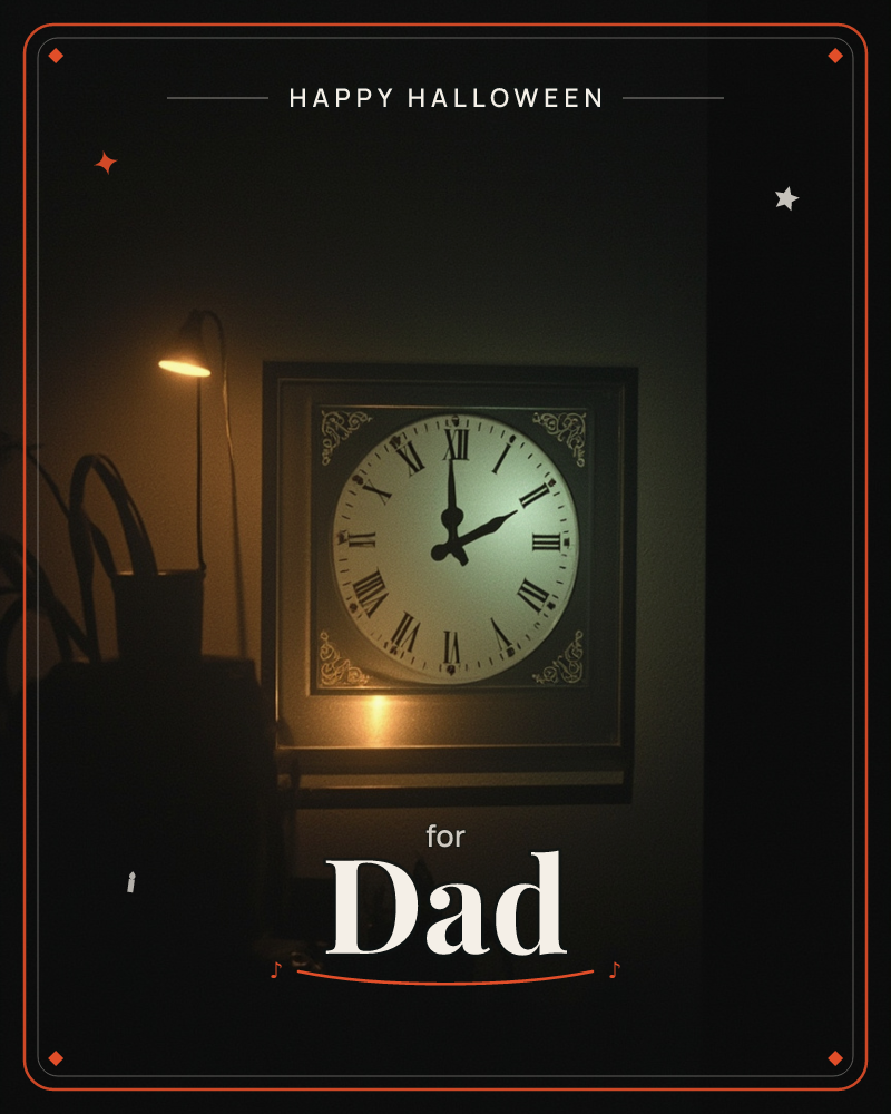 A square-framed wall clock with roman numerals glows softly in an otherwise dark room, lit from below by a small curved desk lamp beside a leafy plant, a halloween e-card design