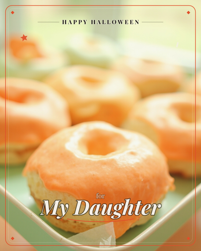 A close-up photograph shows a batch of glazed doughnuts with glossy orange icing, arranged on a pale green tray by a sunlit window, a halloween e-card design