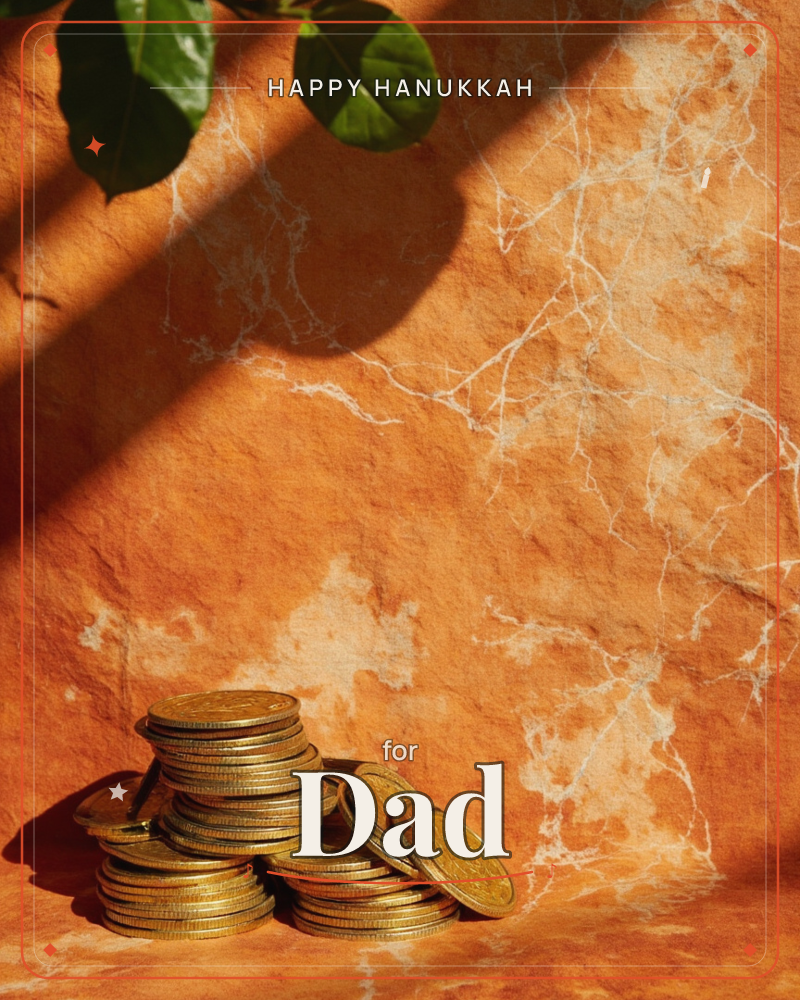 A pair of stacked gold coin piles sit against a sun-warmed terracotta wall, its surface veined with pale marbled cracks, a hanukkah e-card design