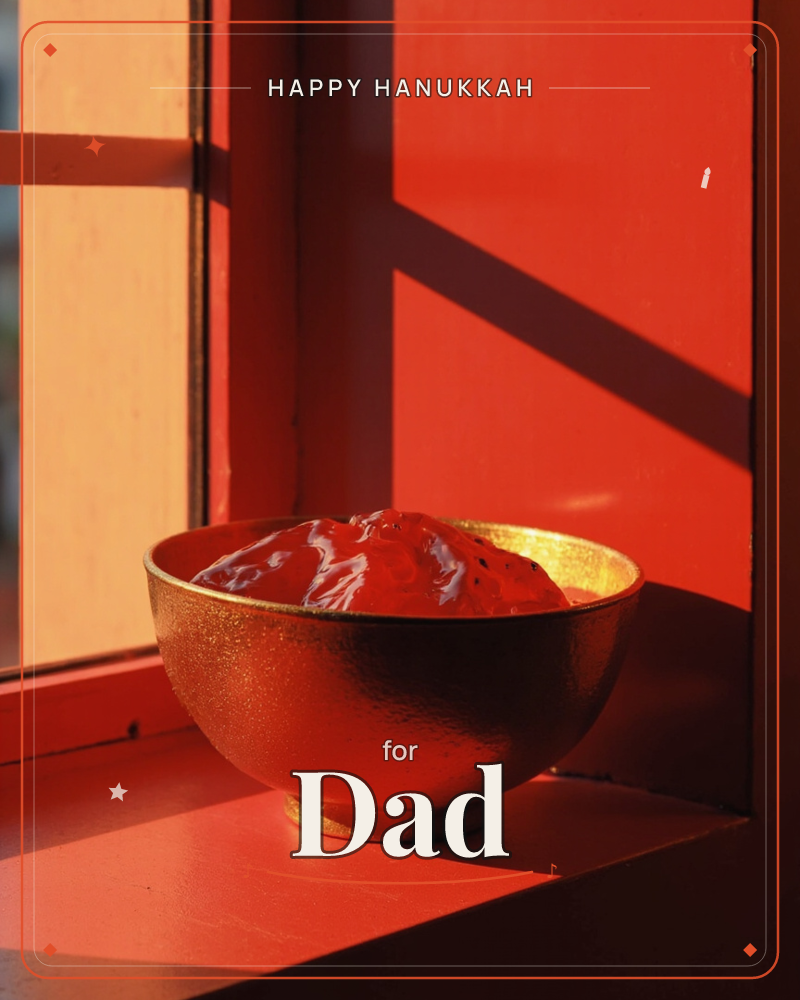 A gilded bowl sits on a windowsill catching the last low light of day, its metallic surface glowing amber and copper as a red-washed wall behind it…, a hanukkah e-card design