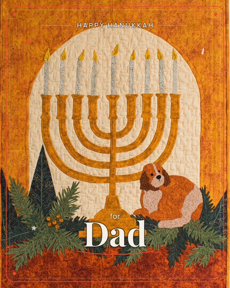 A quilted textile illustration shows a golden nine-branched menorah with all candles lit, glowing inside a pale archway stitched with fine quilting lines, a hanukkah e-card design