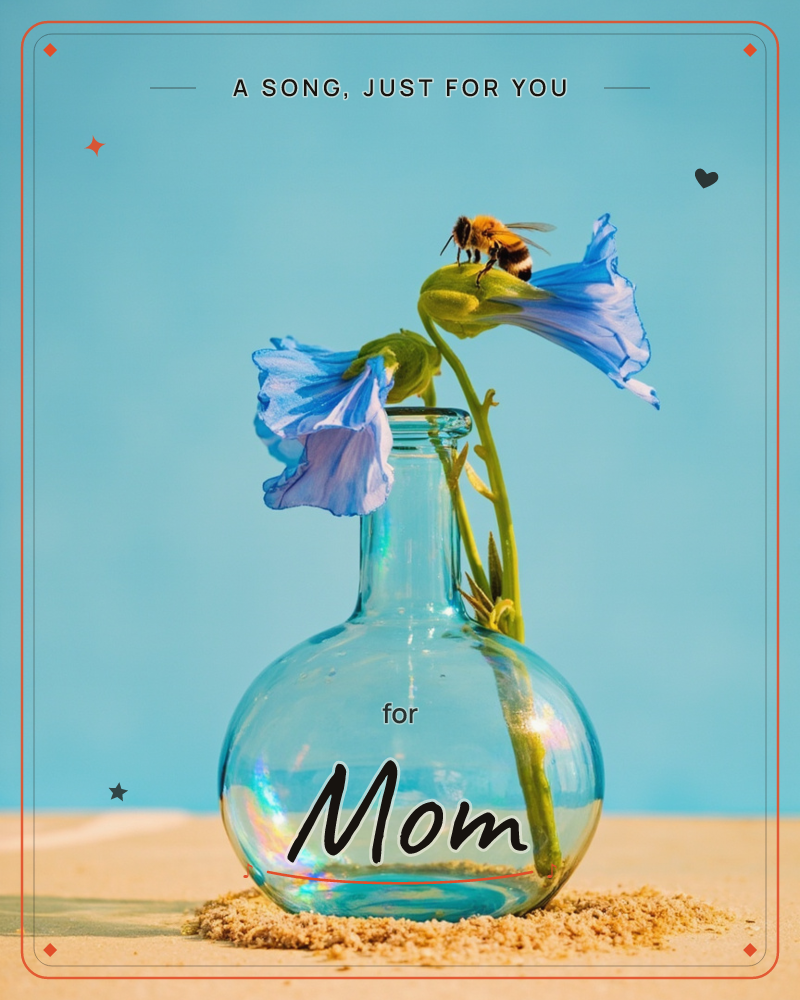 A round glass bottle stands on sand against a clear blue sky, holding two trumpet-shaped blue flowers on curling green stems, a just because e-card design