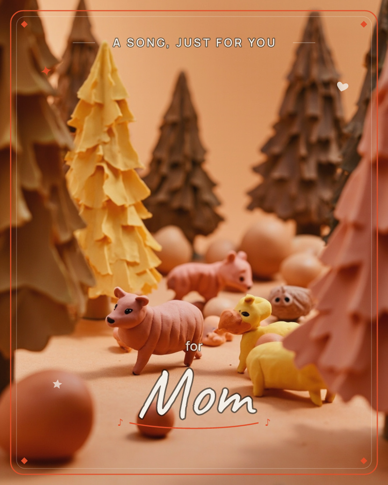 A miniature diorama forest of textured felt-like trees in mustard yellow, dusty rose, and warm brown surrounds a handful of small clay animal figures…, a just because e-card design