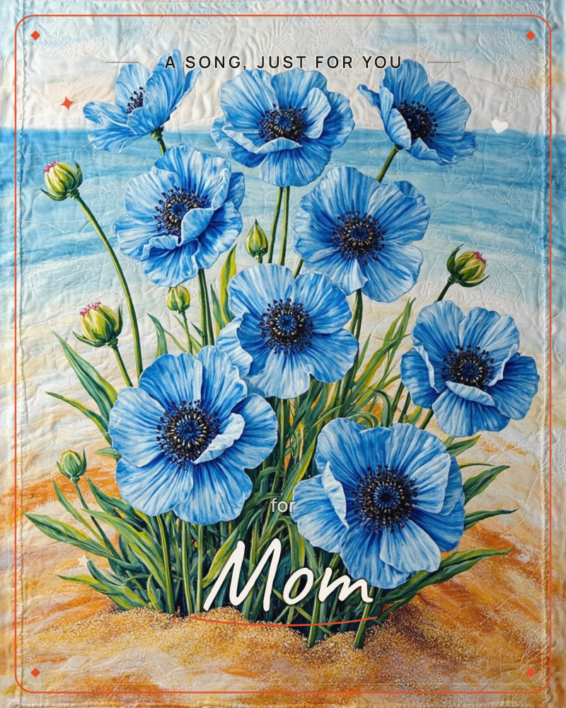 A cluster of vivid blue poppies rises from a sandy dune with a pale ocean and sky stretching behind them, a just because e-card design