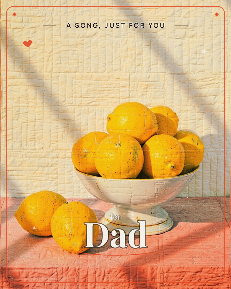A pedestal bowl piled high with sun-ripened lemons sits on a coral-pink tablecloth against a pale quilted wall, everything textured like stitched fabric, a just because e-card design