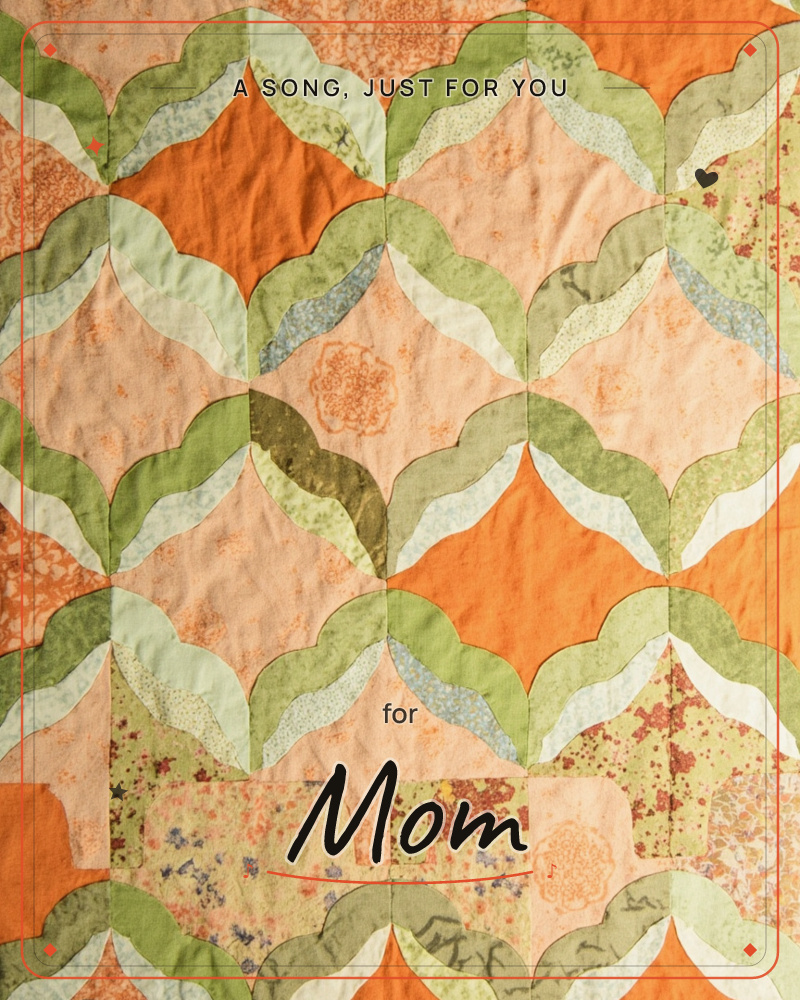 A patchwork quilt fills the frame, its scalloped, petal-shaped pieces stitched into a repeating lattice of leaf greens and warm orange, a just because e-card design
