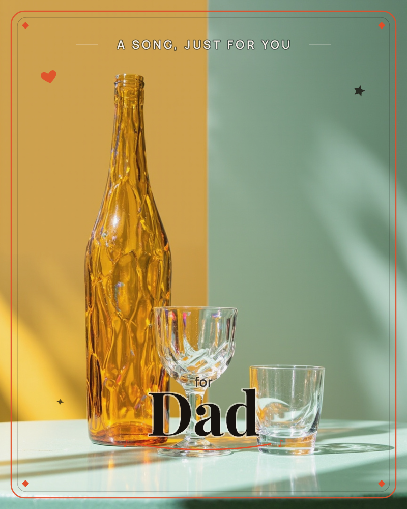 A textured amber glass bottle stands beside a cut-crystal wine glass and a short tumbler on a pale tabletop, split behind by a wall painted half…, a just because e-card design