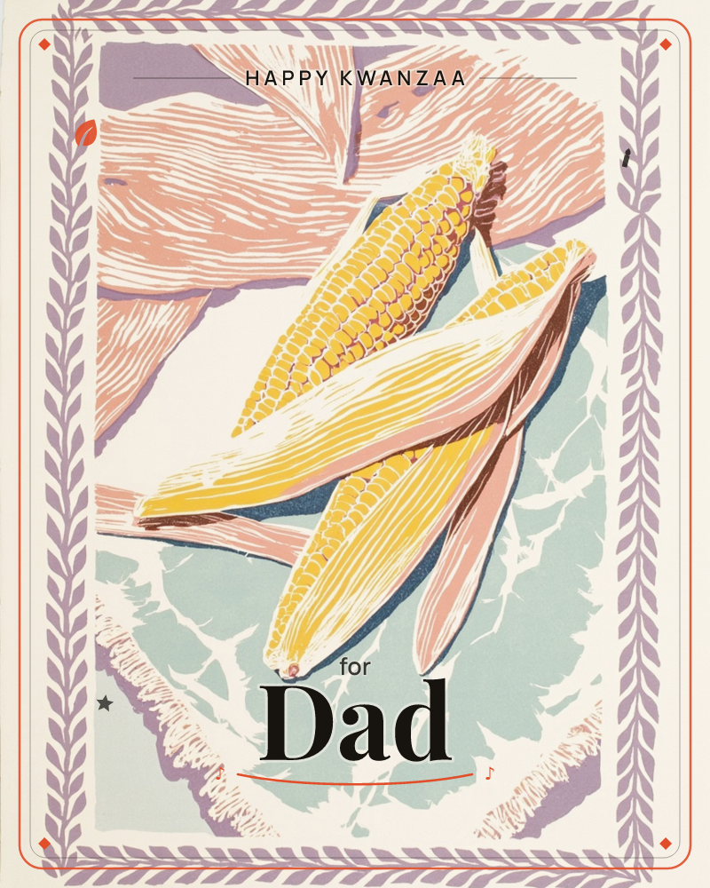 A linocut-style print shows two ears of corn with peeled-back husks resting diagonally across a wooden surface and a pale woven cloth, a kwanzaa e-card design