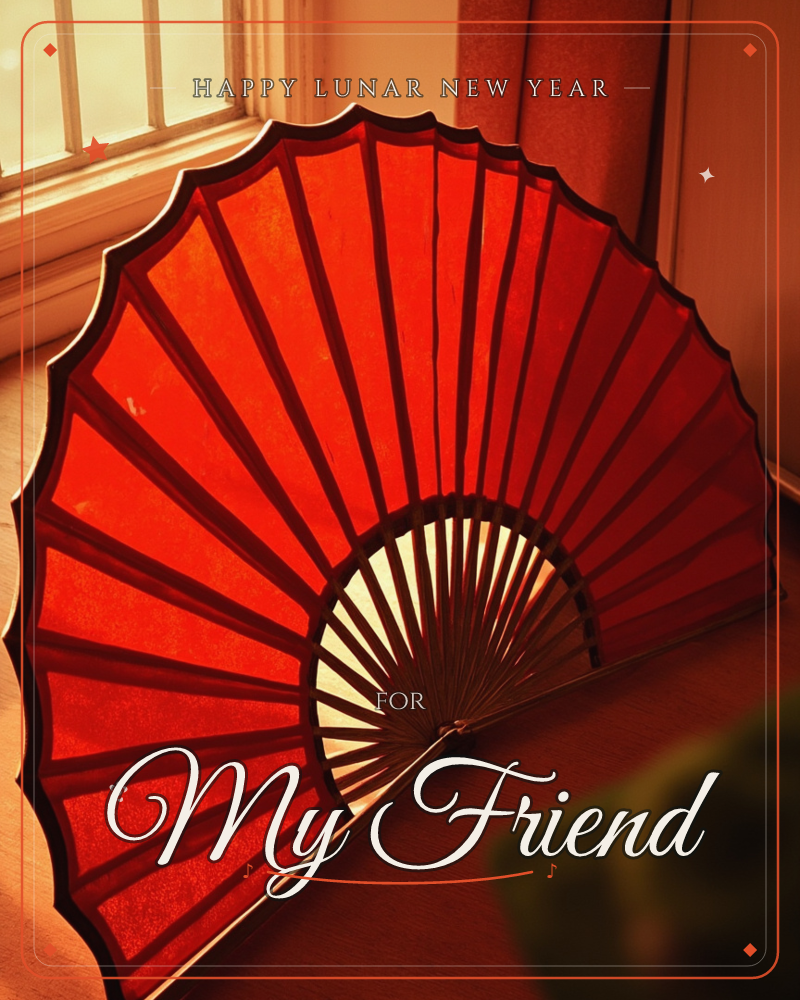 A large red paper fan sits open on the floor beside a sunlit window, its ribs fanning out in a wide arc against warm wooden boards, a lunar new year e-card design
