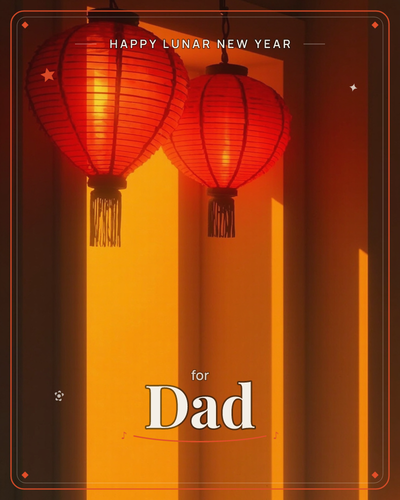 Two round red lanterns hang from dark chains against a wall washed in deep amber light, their silk ribs glowing where the sun cuts through, a lunar new year e-card design