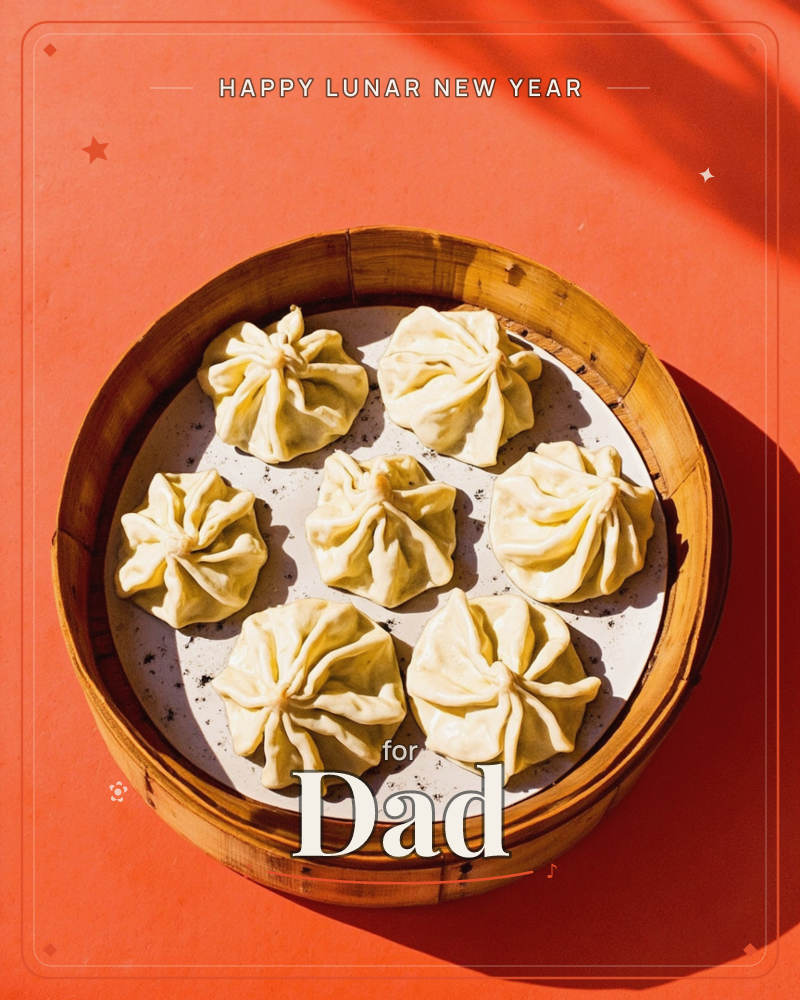 A round bamboo steamer basket sits on a bold orange surface, holding seven neatly pleated dumplings arranged on a speckled white plate, a lunar new year e-card design