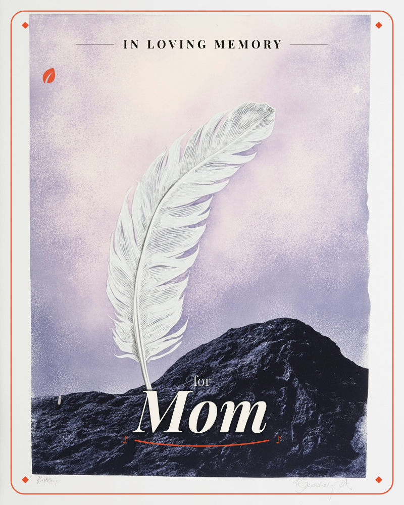A single white feather stands upright, wedged into the peak of a dark rocky mound, set against a hazy lavender-and-cream sky, a memory e-card design