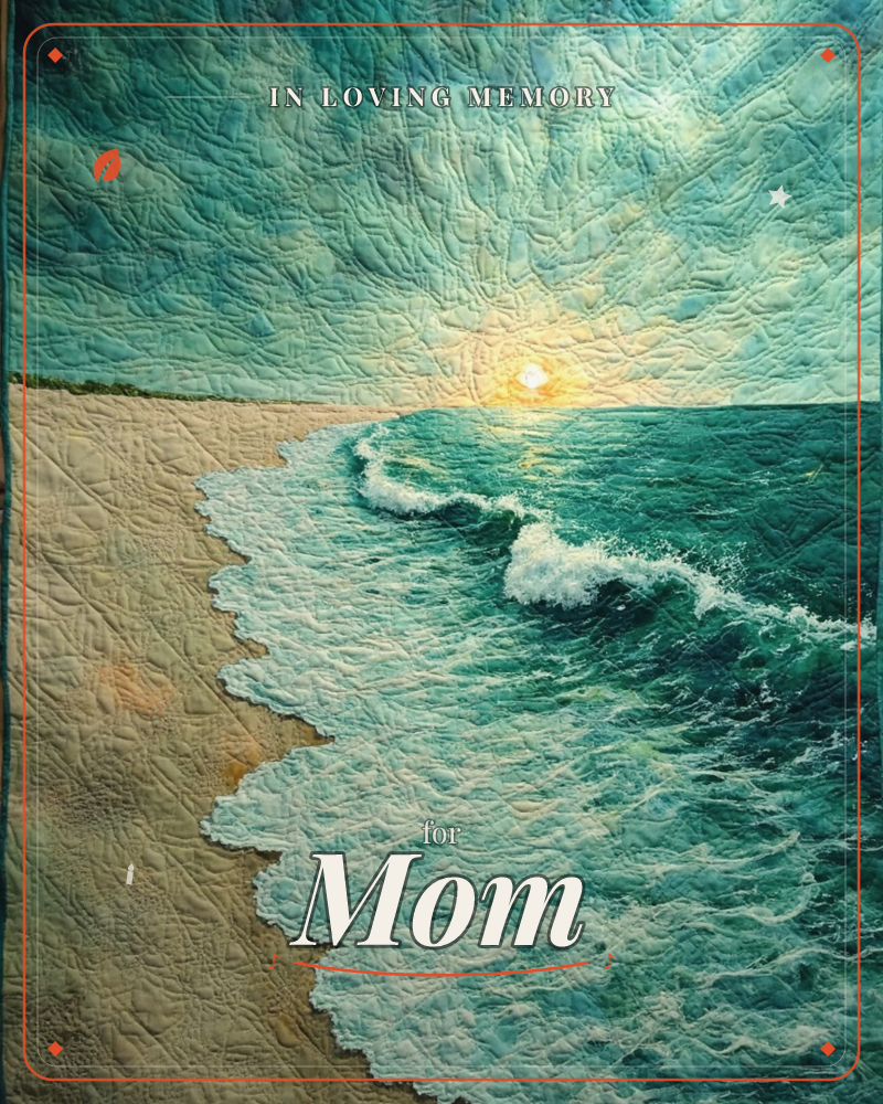 A quilted textile artwork shows a beach at sunrise, the sun a small pale glow low on the horizon where sky meets sea, a memory e-card design