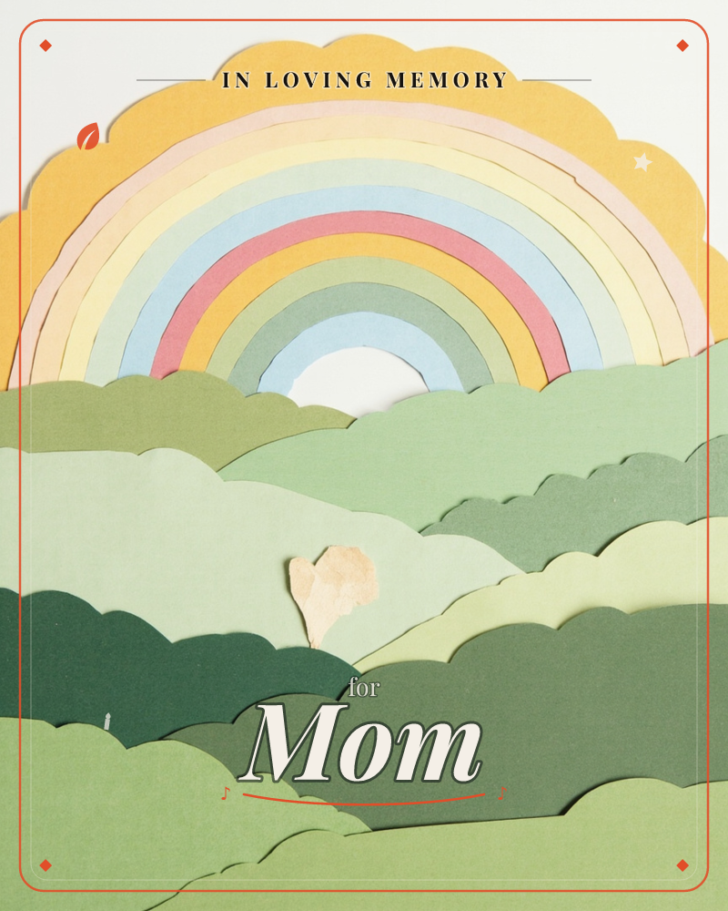 A paper-cut rainbow arcs over layered scalloped hills, each shape cut from coloured card to build gentle depth and shadow, a memory e-card design