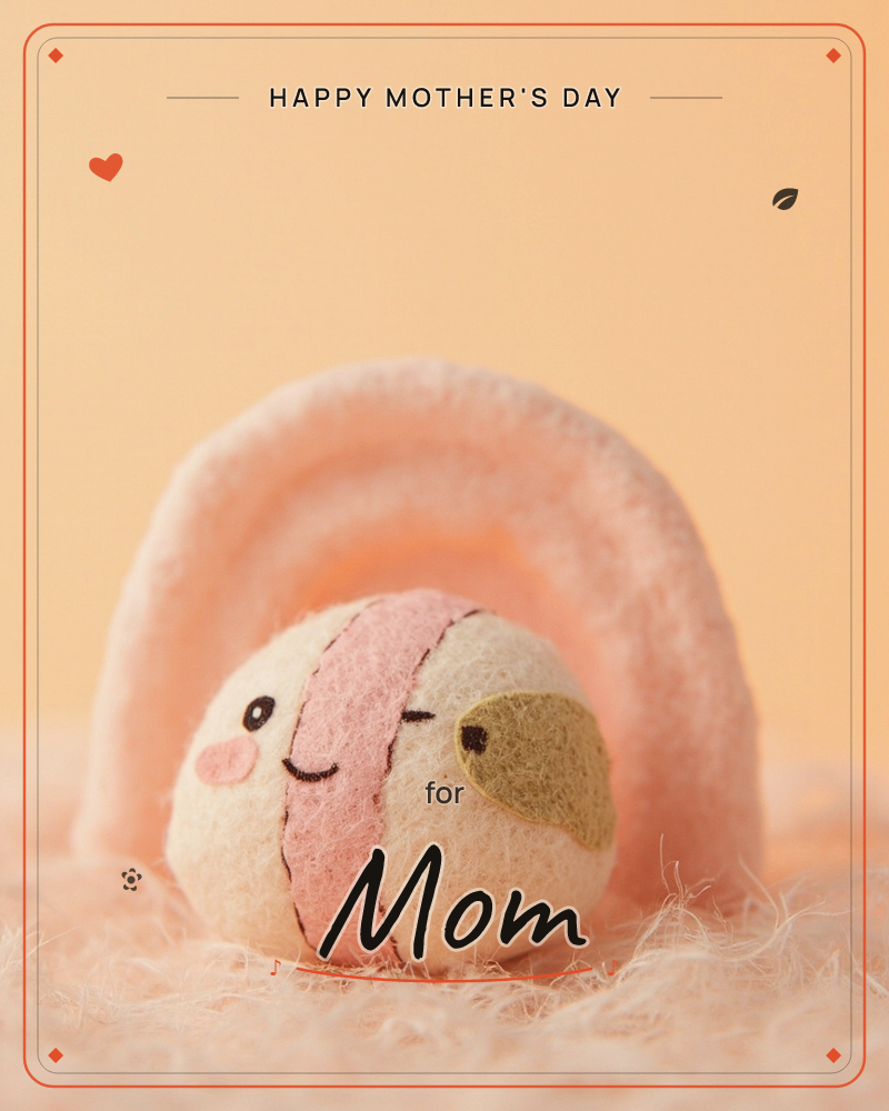 A small felted-wool figure with a stitched smiling face and a golden beak nestles under a plush peach-toned arch, sitting on a fuzzy fibre surface, a mothersday e-card design