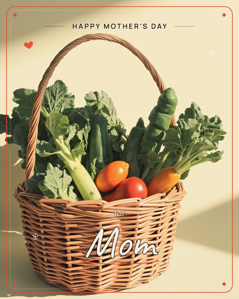 A woven wicker basket sits against a plain cream backdrop, filled with fresh cucumbers, leafy greens, and ripe orange and red tomatoes, a mothersday e-card design