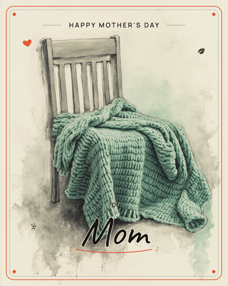 A simple wooden slat-back chair holds a thick, chunky-knit blanket draped loosely over its seat and rail, sagging softly with weight and warmth, a mothersday e-card design