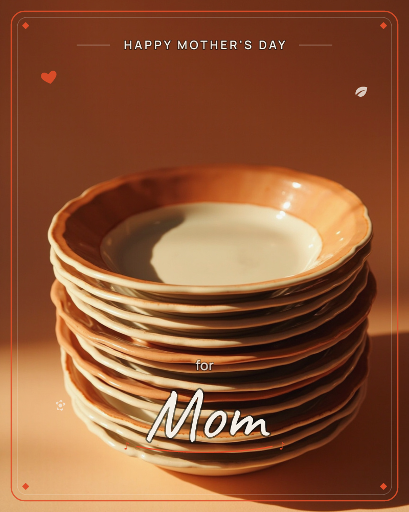 A stack of scalloped-edged plates glazed in warm terracotta and cream sits on a glossy dark surface, catching a single dramatic beam of light, a mothersday e-card design