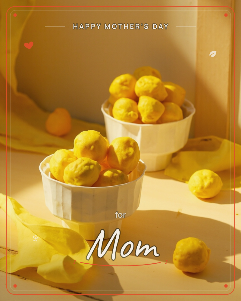 Two white bowls brim with knobbly bright-yellow fruit, their sunlit skins casting long shadows across a pale wooden surface, a mothersday e-card design