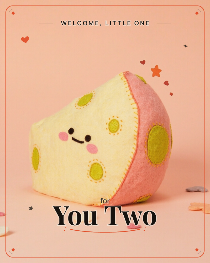 A plush felt cheese wedge with a stitched smiling face and blushing pink cheeks sits against a soft peach background, dotted with olive-green felt…, a new baby e-card design