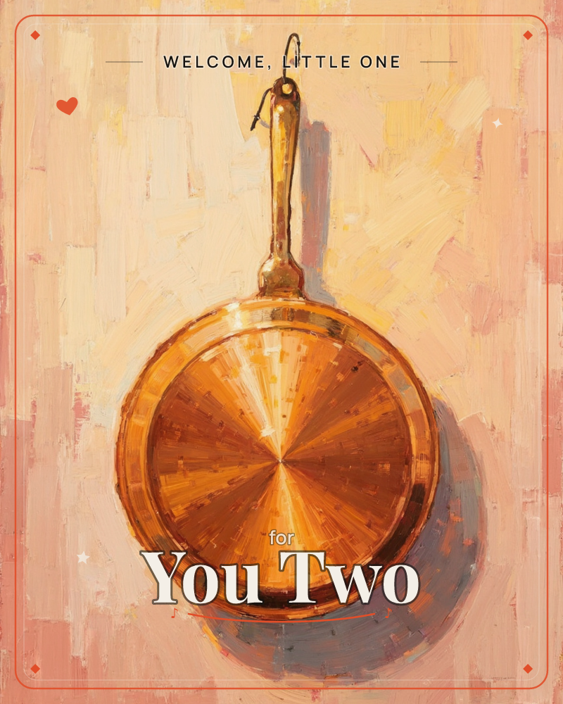 A copper frying pan hangs from a hook against a warm, loosely painted wall of peach, cream and blush strokes, a new baby e-card design