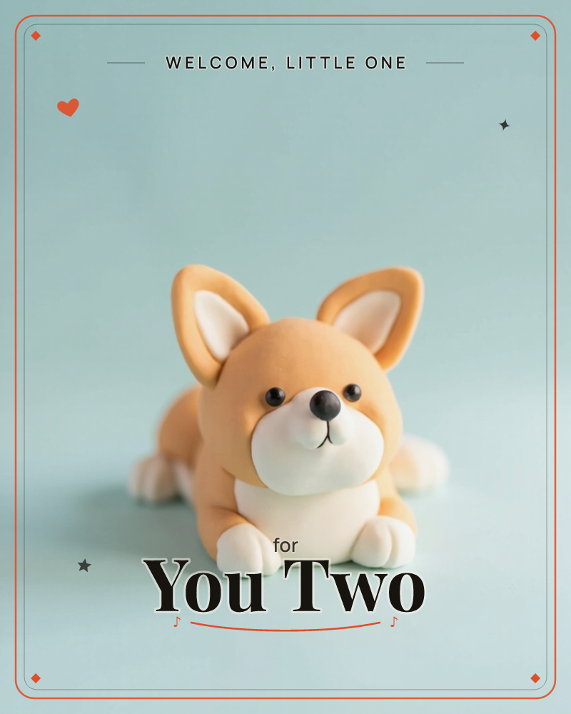 A small clay corgi figure lies flat with its paws stretched out, ears perked up and round black eyes looking straight ahead, a new baby e-card design