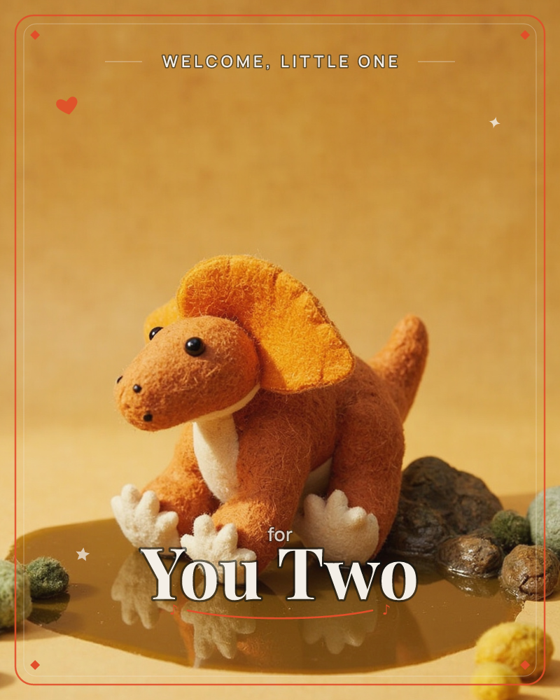 A felt dinosaur toy with a rust-brown body, cream claws and belly, and a bright orange fan-shaped crest stands on a glossy amber surface, a new baby e-card design