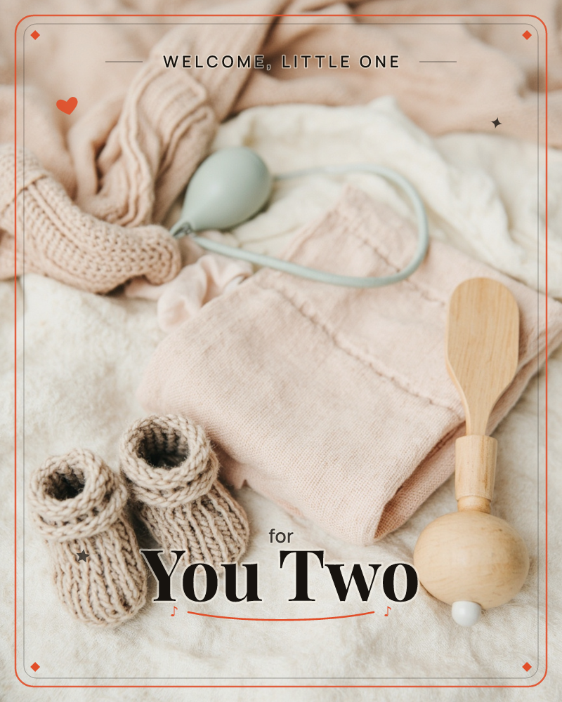 A soft still-life of newborn things laid across a rumpled cream blanket: knitted booties, a folded pink linen garment, a pale blue rattle on a curved…, a new baby e-card design