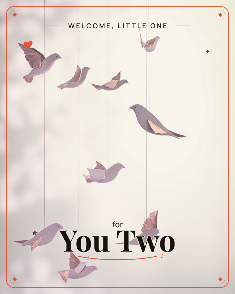 Paper-cut birds in soft mauve and cream hang from fine threads against a glowing, misty backdrop, as if suspended mid-flight in a quiet room, a new baby e-card design