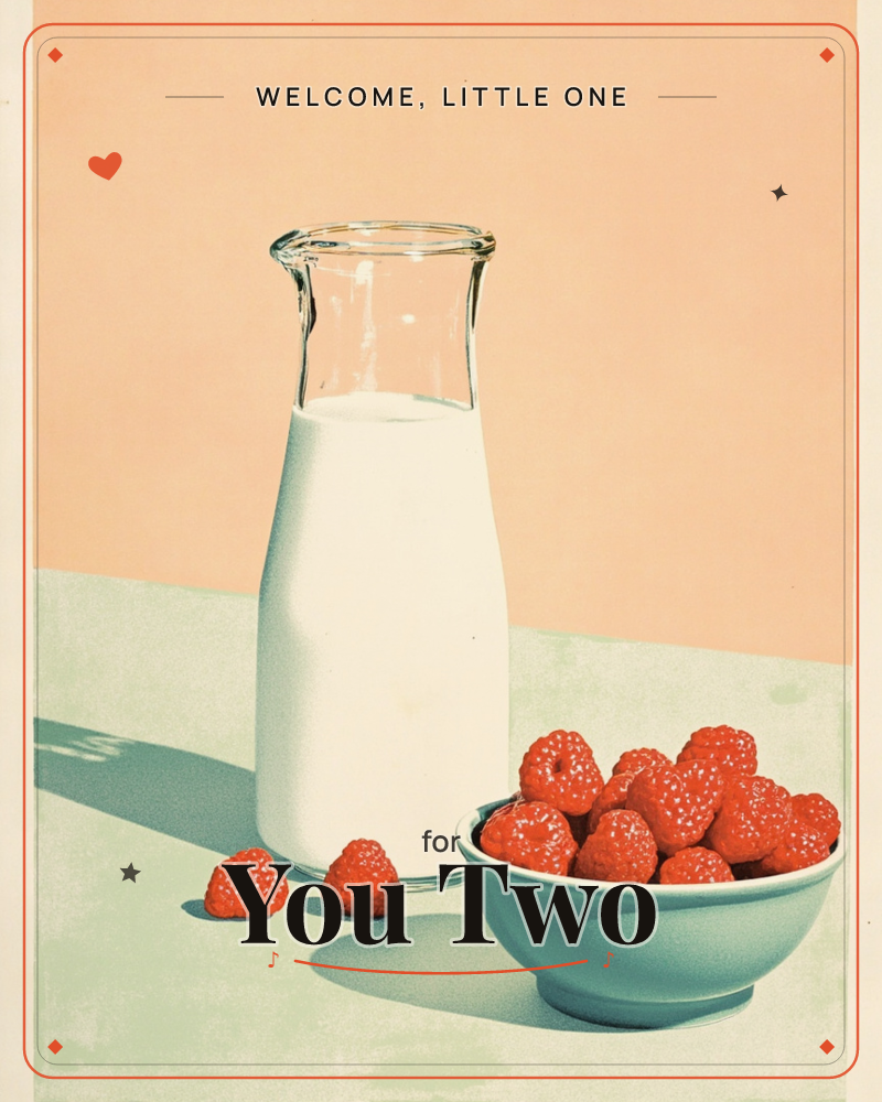 A glass carafe of milk stands beside a pale blue bowl heaped with raspberries, two stray berries dropped nearby on the tabletop, a new baby e-card design