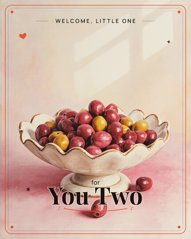 A scalloped white pedestal bowl edged in gold sits piled high with plump red and golden plums, two fallen fruits resting on the pale pink surface below, a new baby e-card design
