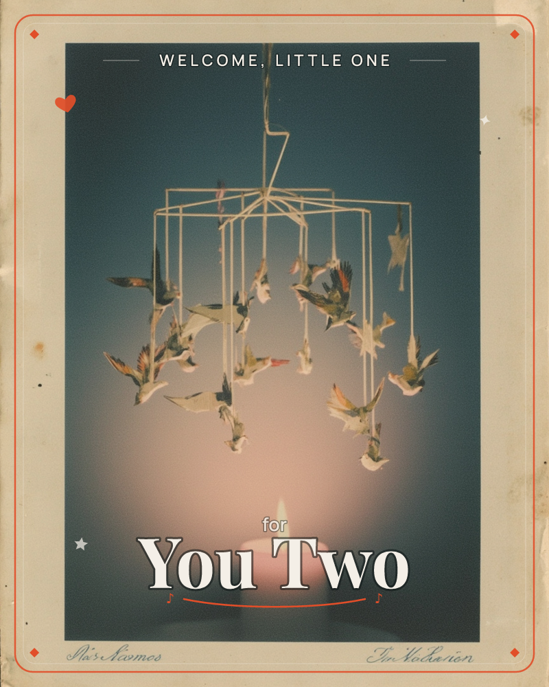 A vintage-style photograph shows a hanging mobile of small paper birds suspended from a wire frame, caught mid-flutter against a deep teal backdrop, a new baby e-card design
