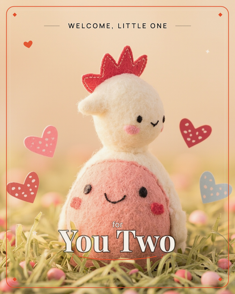 A felted wool chicken figure with a stitched red comb sits nestled in a bed of grass, its round pink body giving it a plump, huggable shape, a new baby e-card design