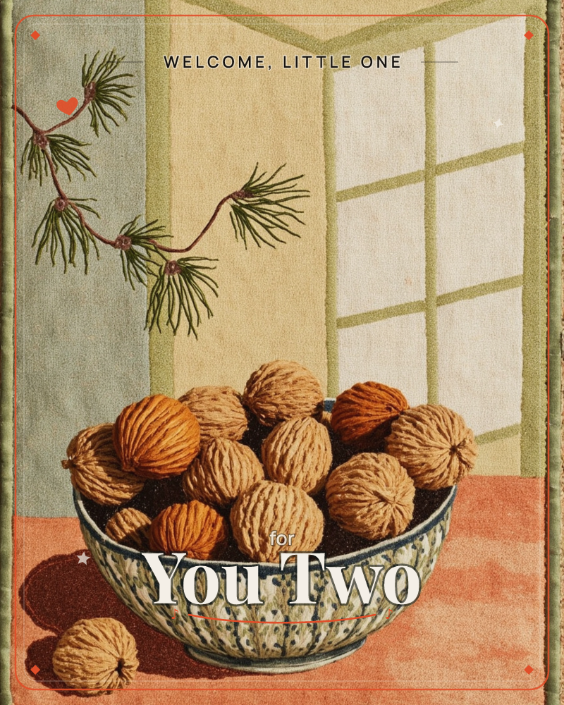 A patterned bowl sits piled high with walnuts on a coral-toned tabletop, one nut fallen loose beside it, a new baby e-card design