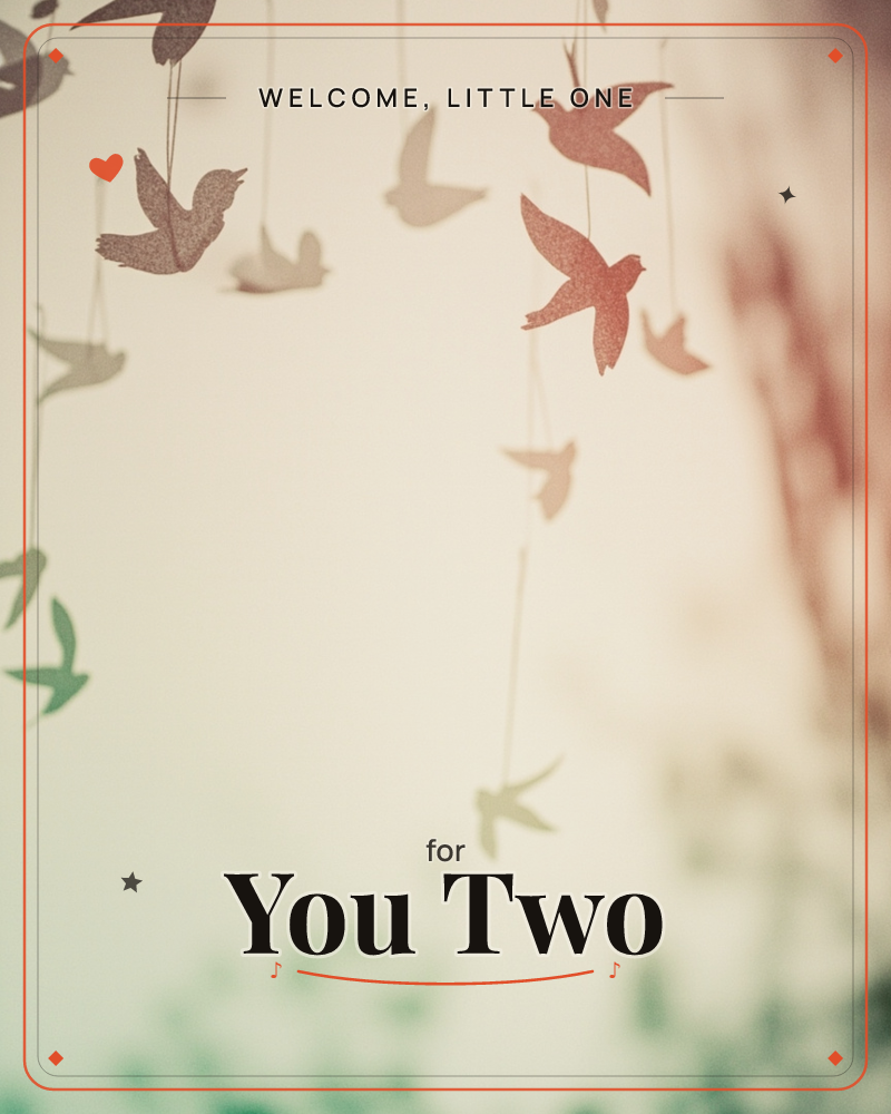 Paper bird silhouettes hang from fine threads at different depths, drifting in soft focus against a pale, warm-lit backdrop, a new baby e-card design