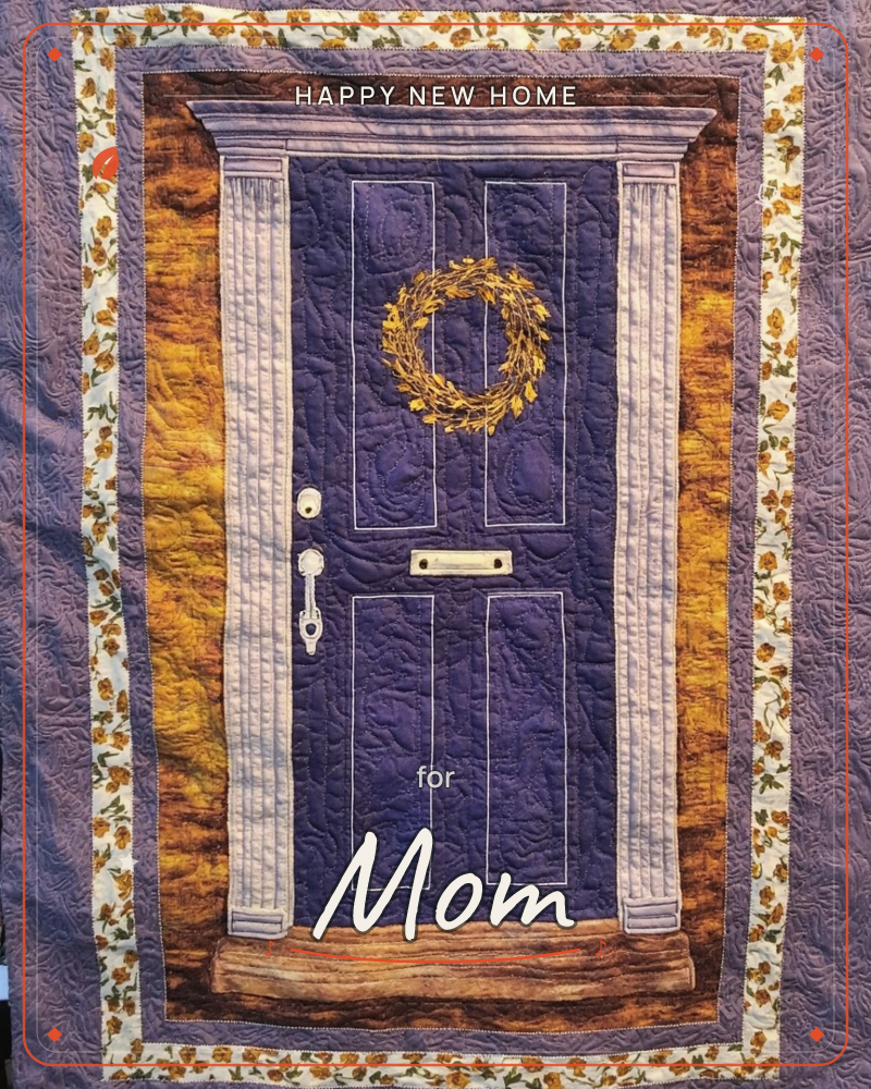 A quilted textile design shows a purple front door framed by weathered stone columns, with a small golden wreath hung at its center and a brass…, a new home e-card design