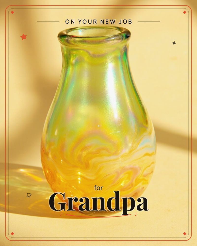 A single glass bud vase catches warm sunlight, its swirled surface shifting between amber, gold and iridescent green, a new job e-card design