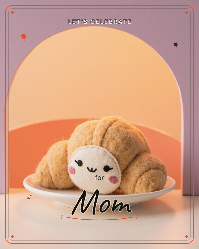 A felted, fuzzy croissant sits piled on a small white plate, with a round smiling felt face and rosy cheeks stitched onto its front, a party e-card design