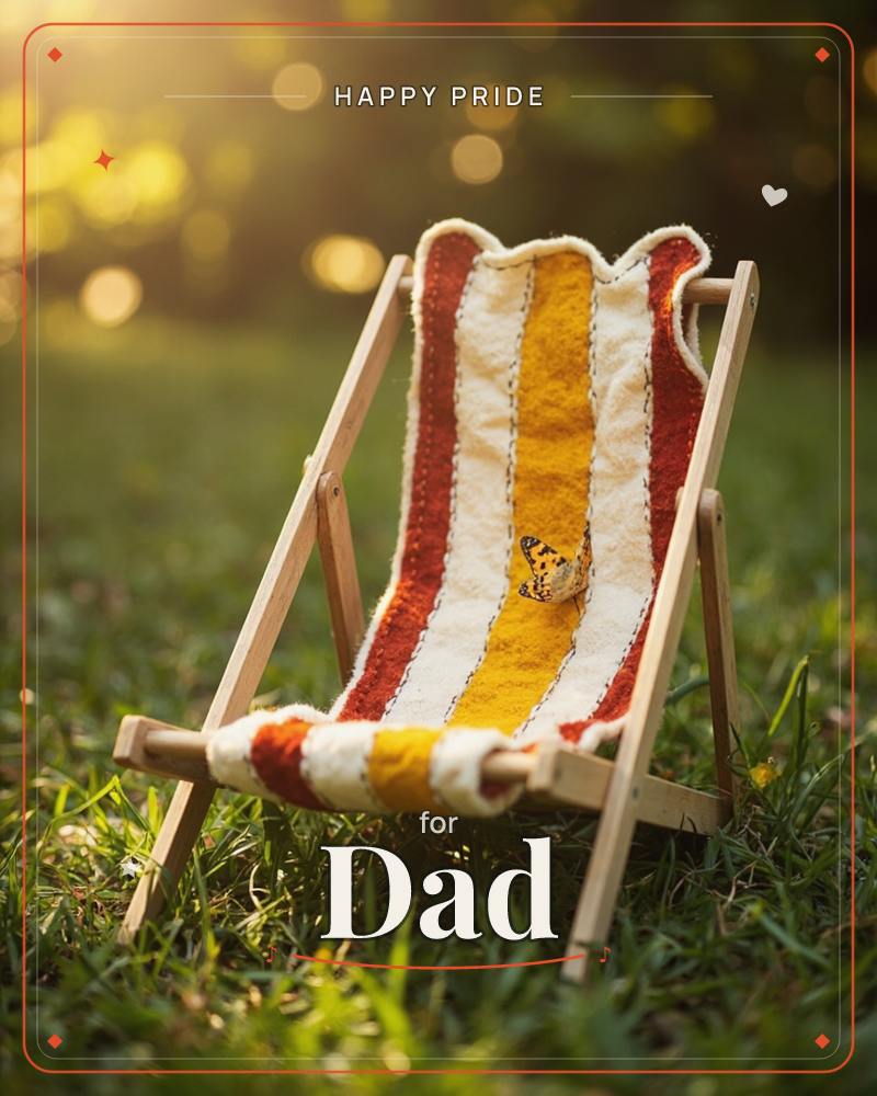 A tiny wooden deckchair with a red, mustard and cream striped canvas sits on a lawn, glowing in late golden sunlight, a pride e-card design