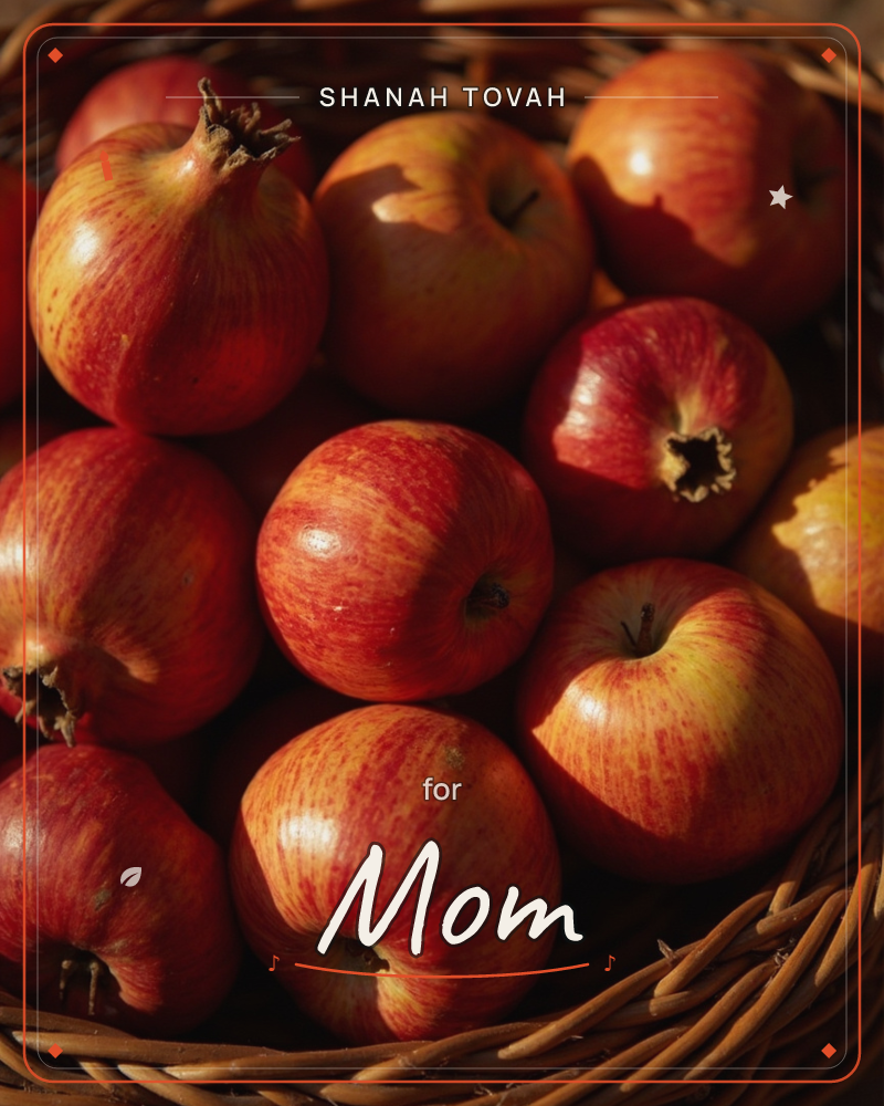 A woven basket brims with red-gold apples and a pomegranate, caught in a shaft of low, warm sunlight that carves deep shadows between the fruit, a rosh hashanah e-card design