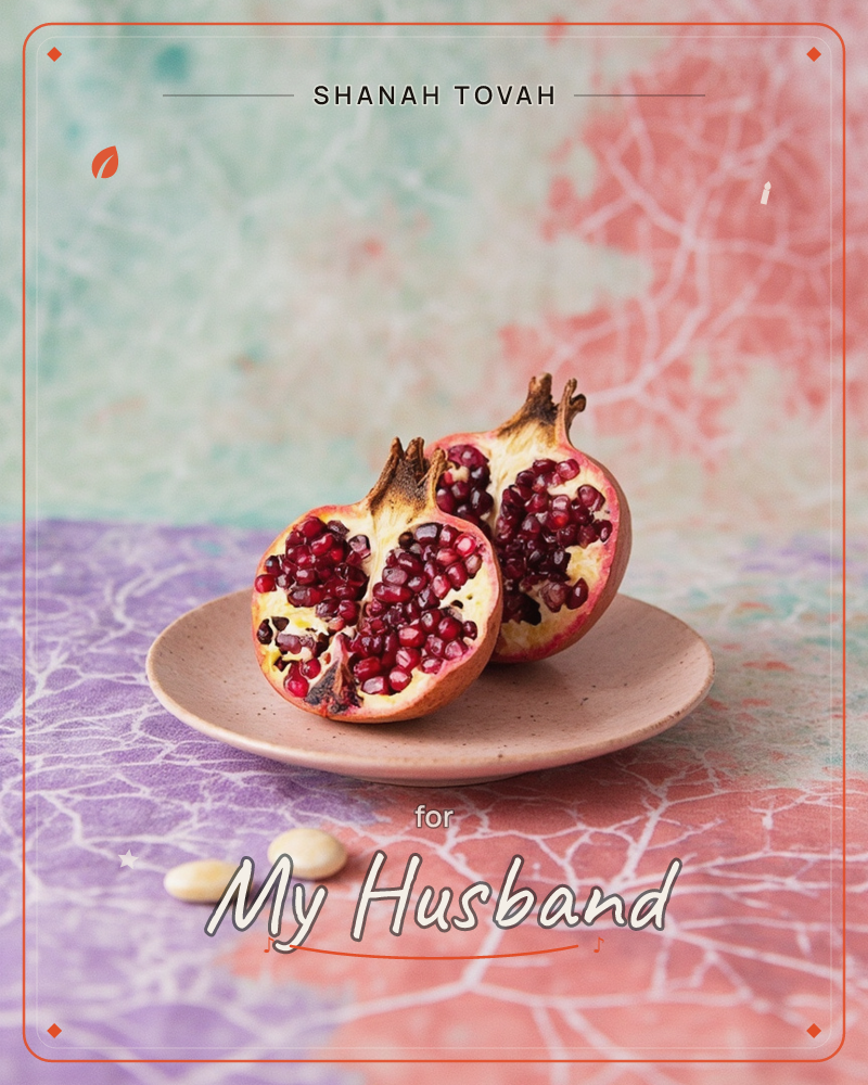 A pomegranate cut in two sits on a small pink ceramic plate, its ruby seeds spilling open against pale flesh, a rosh hashanah e-card design