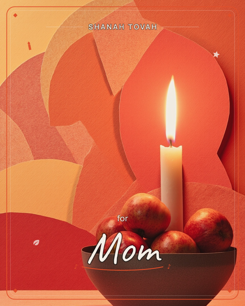 A single lit candle rises from a dark bowl of small red apples, set against a layered paper-cut backdrop of warm orange, coral and cream shapes, a rosh hashanah e-card design