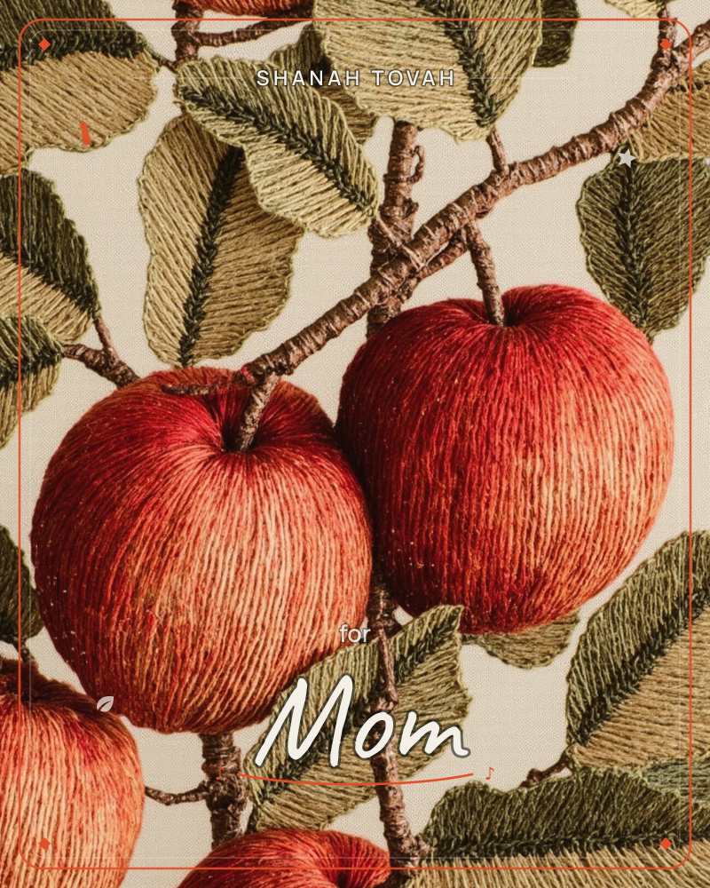 A close-up of two red apples on a branch, rendered entirely in thick embroidered thread so the fruit skin, stems, and leaves show visible stitched texture, a rosh hashanah e-card design