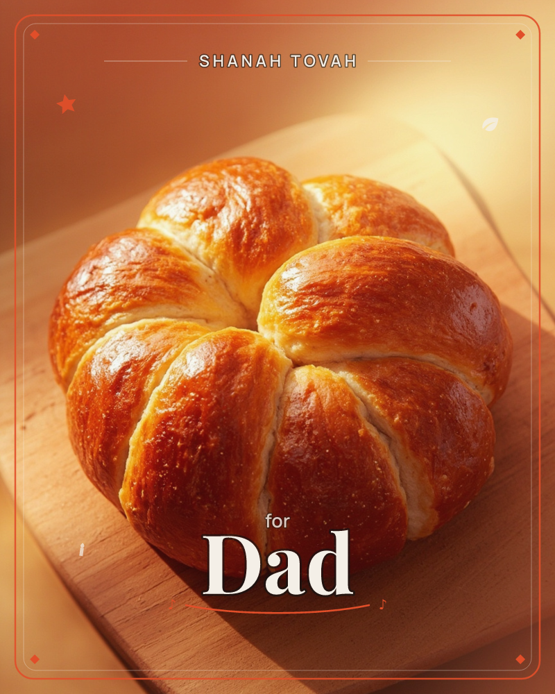 A round pull-apart bread, its glossy golden crust segmented into plump petal-like sections, sits on a pale wooden board, a rosh hashanah e-card design