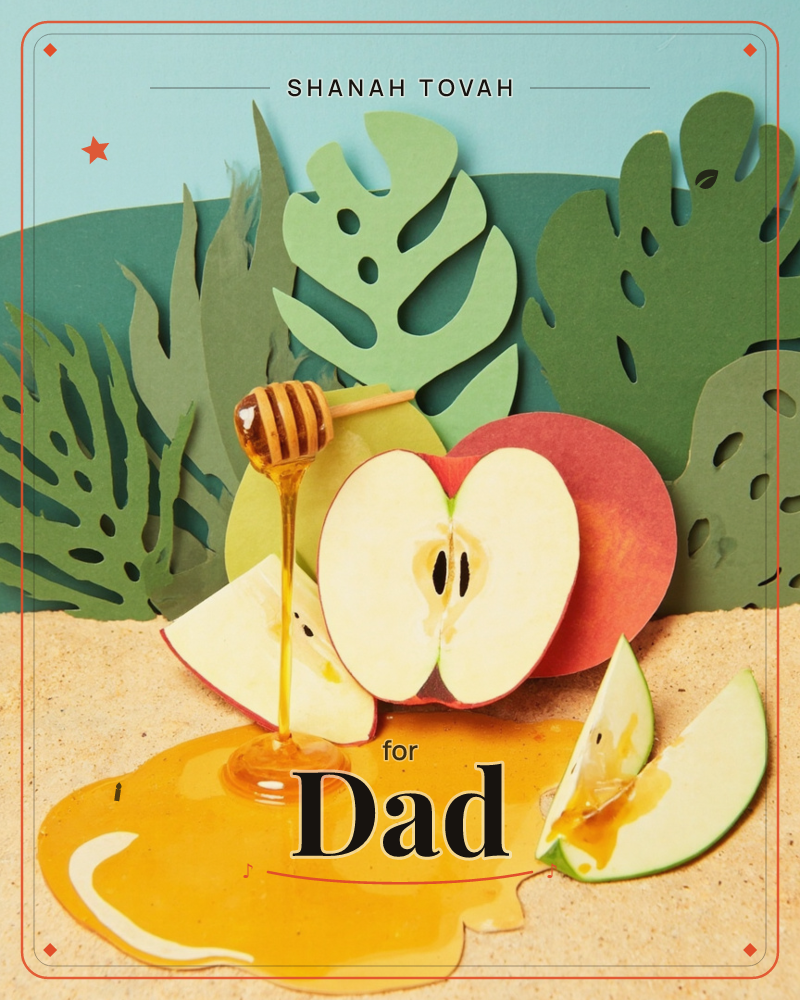A paper-craft still life shows a sliced red apple and apple wedges on a sandy tabletop, with a honey dipper drizzling honey into a golden puddle below, a rosh hashanah e-card design
