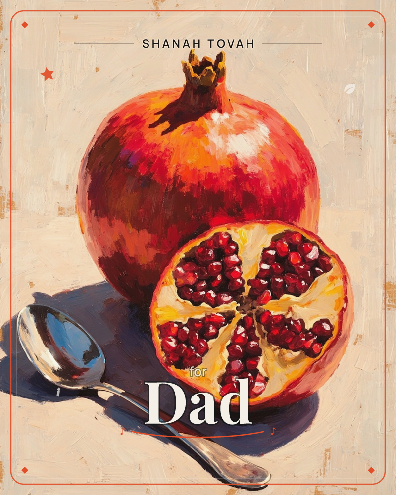 A whole pomegranate and its cut half sit side by side on a pale tabletop, ruby seeds glinting where the fruit has been sliced open, a rosh hashanah e-card design