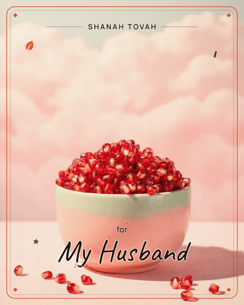 A ceramic bowl glazed pale mint and blush sits piled high with glistening pomegranate seeds, a few scattered loose on the pink surface below, a rosh hashanah e-card design